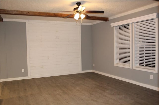 empty room featuring dark wood-type flooring, ceiling fan, and a textured ceiling