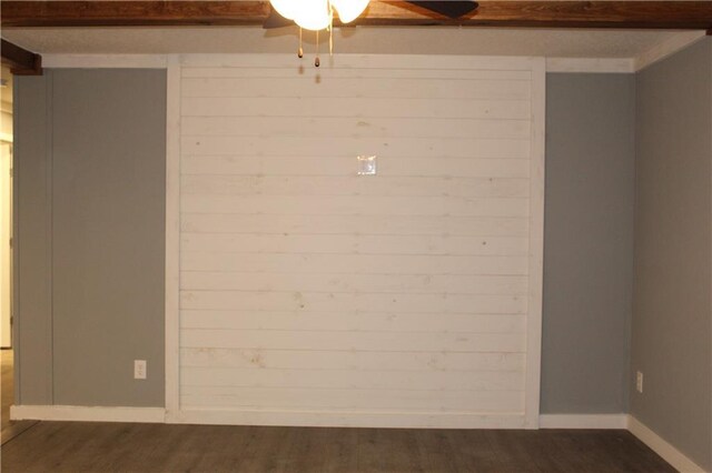 kitchen featuring baseboards, wood finished floors, decorative backsplash, and white cabinets