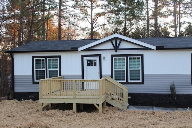 view of front facade featuring crawl space and a wooden deck