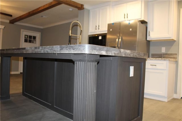 kitchen with wood-type flooring, white cabinets, and stainless steel refrigerator with ice dispenser