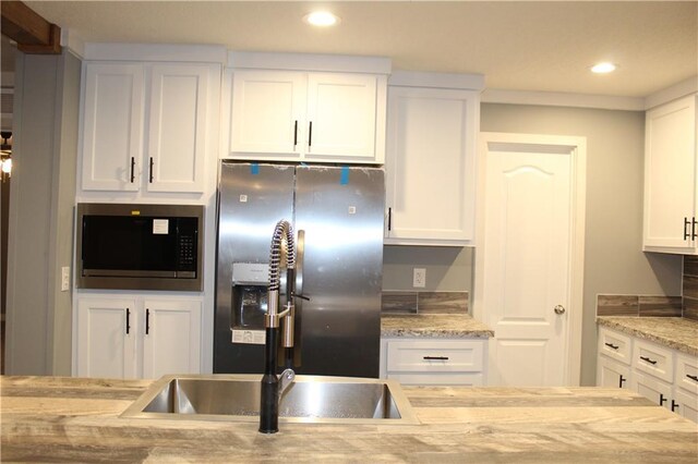 details with stone countertops, white cabinetry, and stove