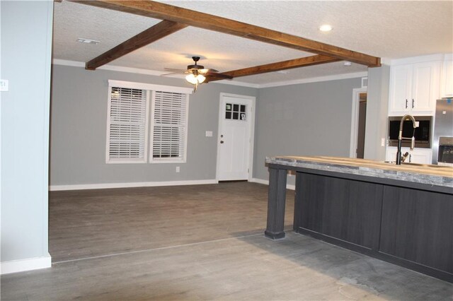 mudroom with dark wood-style flooring and baseboards