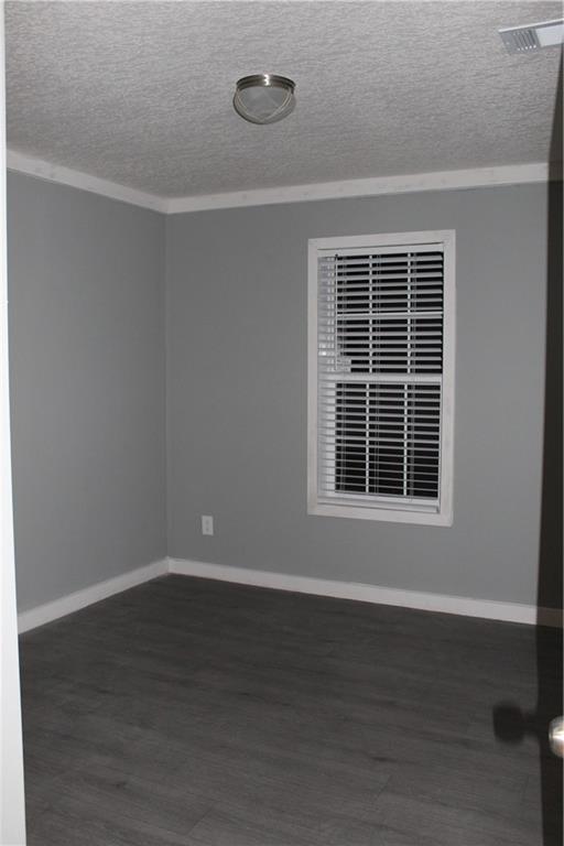 half bathroom with baseboards, vanity, toilet, and wood finished floors