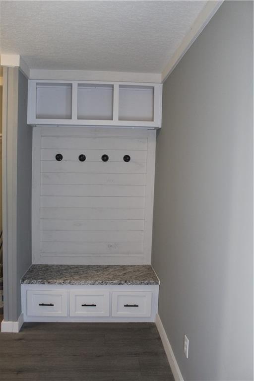 kitchen featuring light countertops, appliances with stainless steel finishes, a center island with sink, and white cabinets