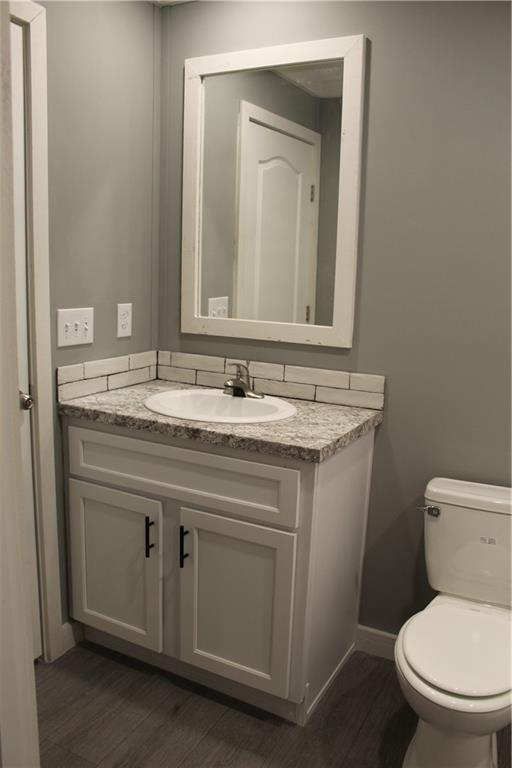 walk in closet with wood-type flooring