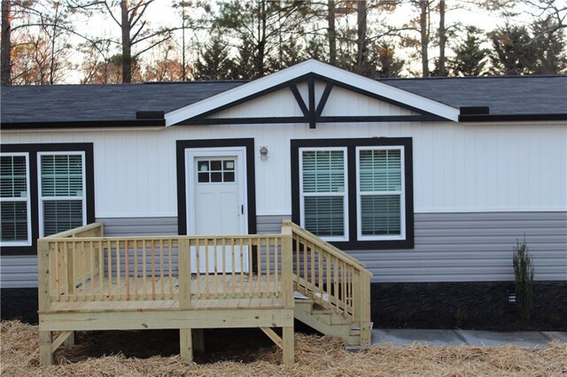 view of side of property with crawl space and a wooden deck