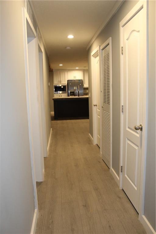 bathroom with a stall shower and wood finished floors