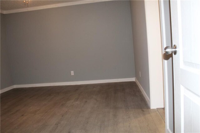 spare room with a textured ceiling, dark wood-style flooring, a ceiling fan, and baseboards