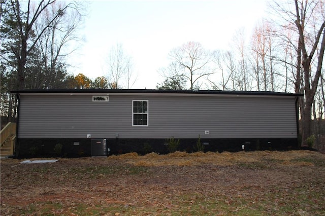 view of side of home with central AC unit