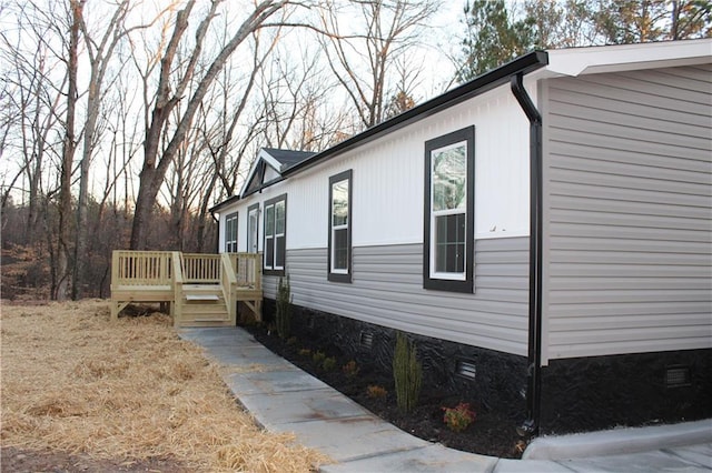 view of home's exterior featuring a wooden deck