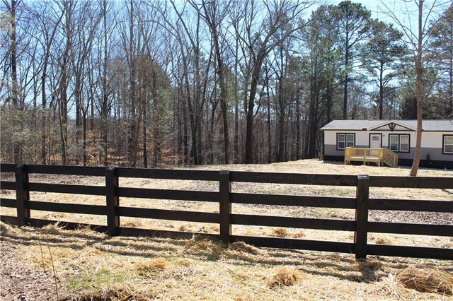 manufactured / mobile home featuring driveway and a wooden deck