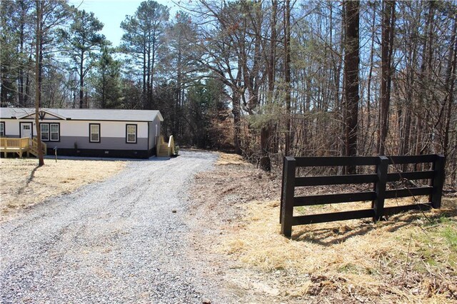 view of front of property featuring crawl space and a deck