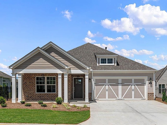 craftsman inspired home with a porch, a garage, and a front lawn