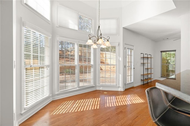 dining space featuring hardwood / wood-style floors and a chandelier