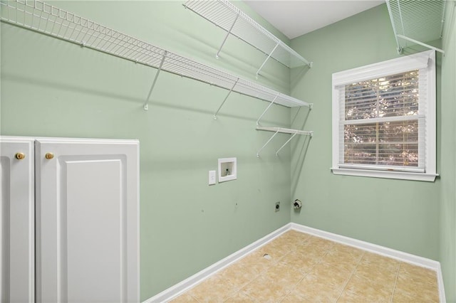 laundry room featuring hookup for a washing machine and light tile patterned floors