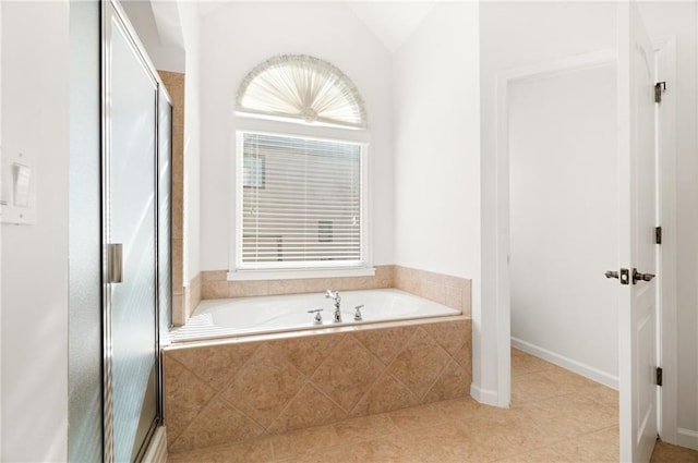 bathroom with tile patterned flooring, vaulted ceiling, and shower with separate bathtub