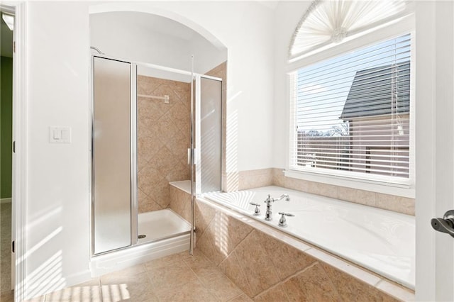 bathroom featuring tile patterned flooring and separate shower and tub