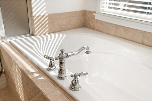 room details featuring tiled bath and radiator