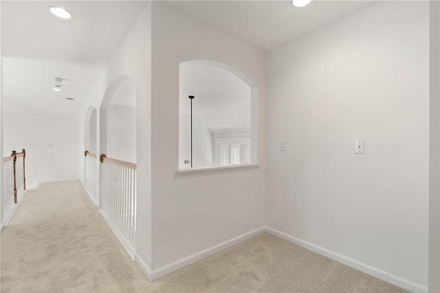 hall featuring light colored carpet