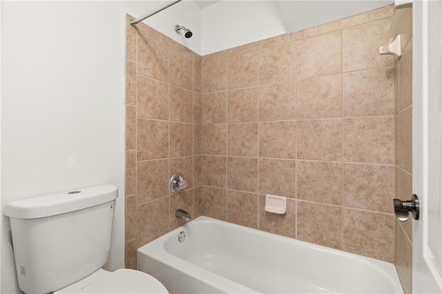 bathroom with tiled shower / bath combo and toilet