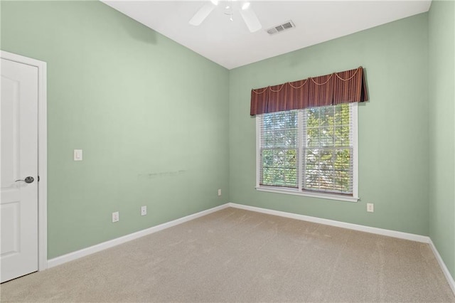 carpeted spare room featuring ceiling fan