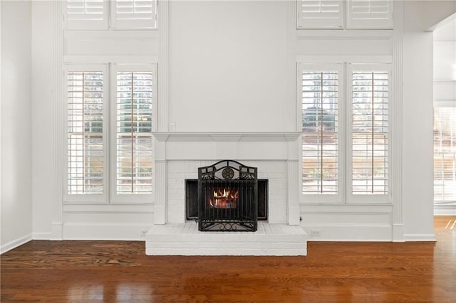 details with a brick fireplace and hardwood / wood-style floors