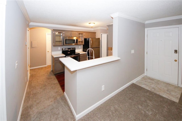 kitchen featuring arched walkways, glass insert cabinets, stainless steel appliances, crown molding, and carpet floors