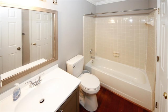 full bath featuring toilet, ornamental molding, wood finished floors, vanity, and shower / washtub combination