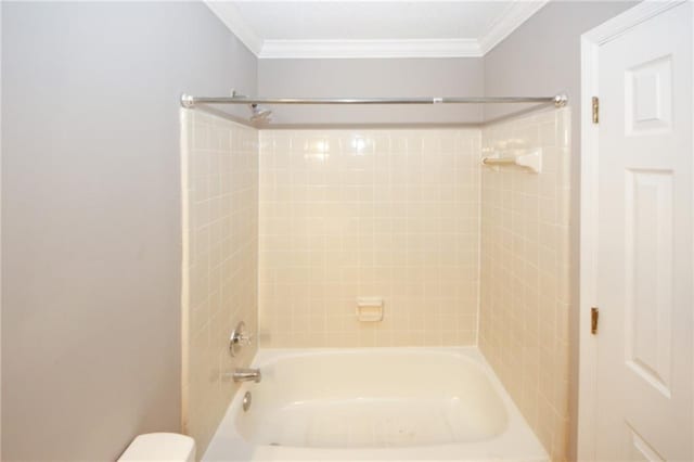 bathroom featuring ornamental molding, shower / washtub combination, and toilet