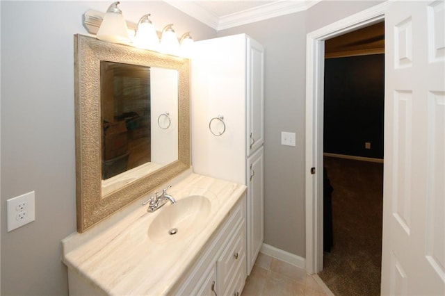 bathroom with baseboards, tile patterned floors, vanity, and crown molding