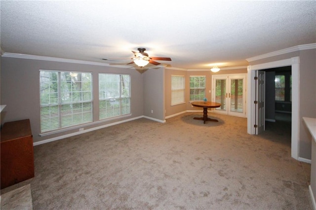 unfurnished living room featuring ornamental molding, carpet, and baseboards