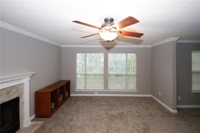 unfurnished living room with carpet floors, a fireplace, baseboards, and ornamental molding