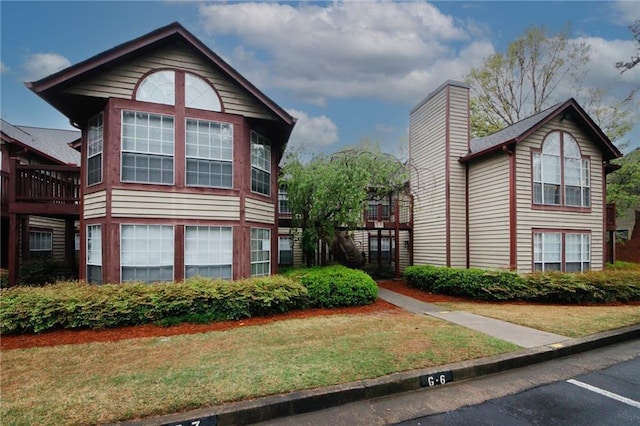 view of property exterior with a yard and an attached garage