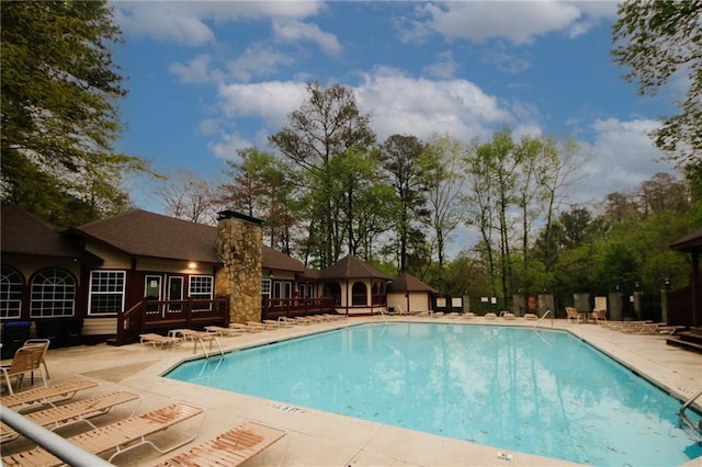 community pool with a patio area and a gazebo