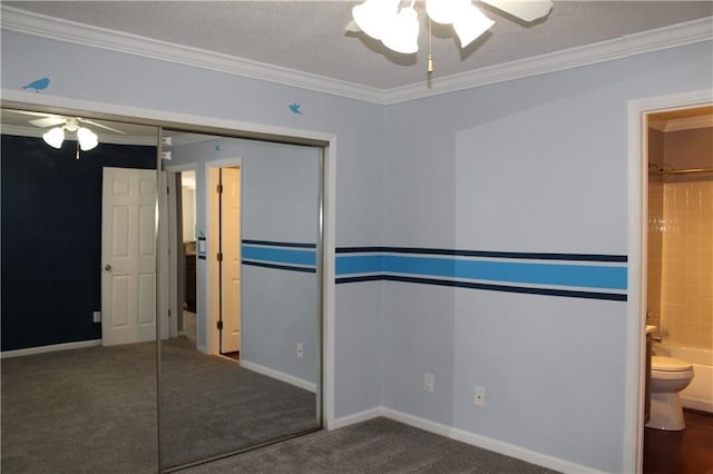 unfurnished bedroom featuring a textured ceiling, connected bathroom, carpet floors, ornamental molding, and a closet