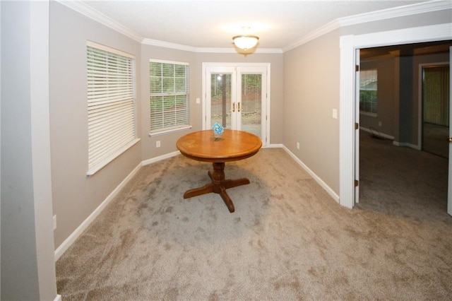 unfurnished dining area with carpet floors, french doors, crown molding, and baseboards