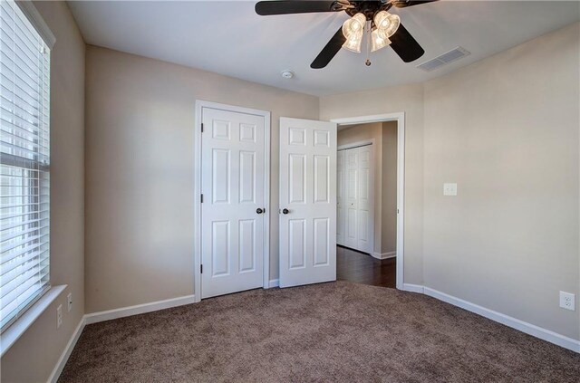 carpeted empty room with ceiling fan