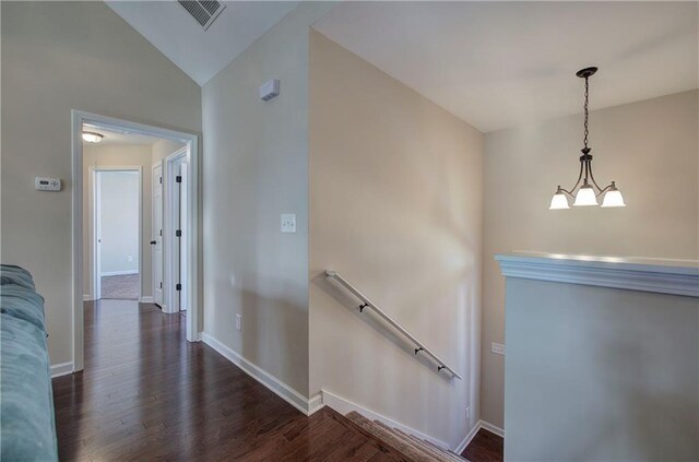 corridor featuring high vaulted ceiling, a chandelier, and dark hardwood / wood-style flooring