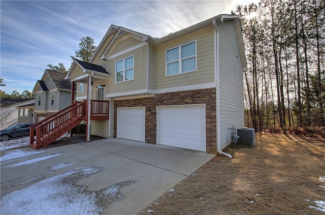 view of front of house with a garage and central AC unit