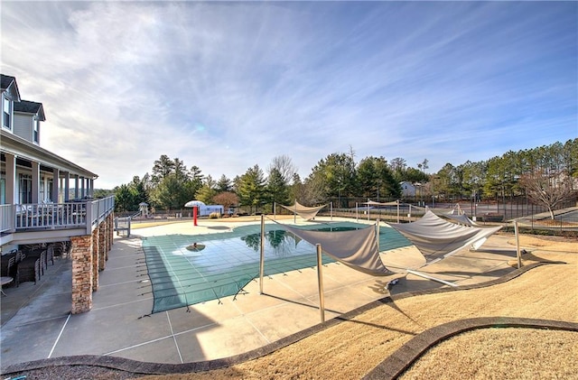 view of swimming pool with a patio area