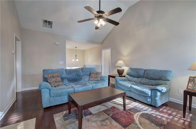 living room featuring high vaulted ceiling, dark hardwood / wood-style flooring, a fireplace, and ceiling fan