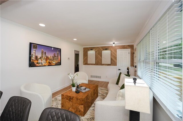 living room featuring crown molding and hardwood / wood-style floors