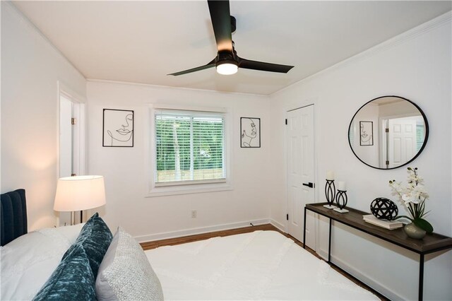 bedroom featuring ceiling fan, ornamental molding, and hardwood / wood-style flooring