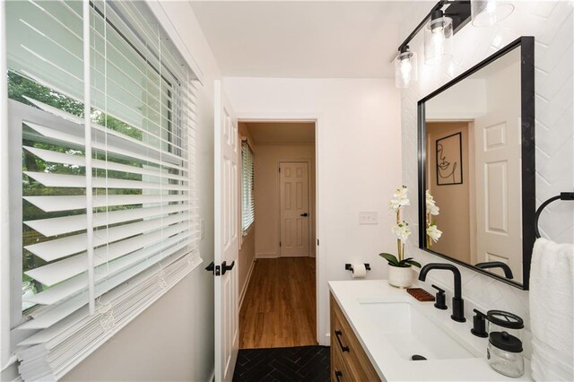 bathroom featuring hardwood / wood-style floors, vanity, and a wealth of natural light