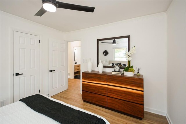 bedroom featuring ceiling fan, light hardwood / wood-style flooring, and crown molding