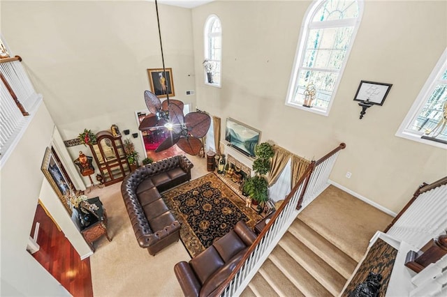 stairs with baseboards and carpet flooring