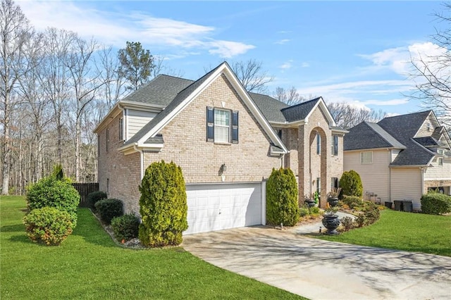 view of side of home featuring an attached garage, a yard, a shingled roof, concrete driveway, and brick siding