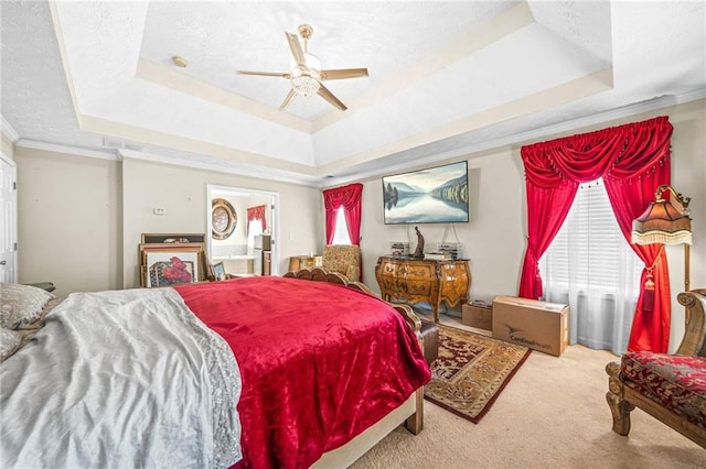 bedroom featuring ornamental molding, a textured ceiling, a raised ceiling, and carpet floors