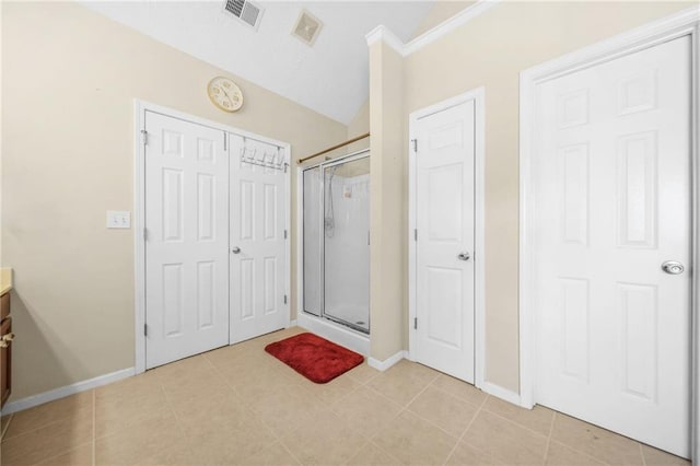 bathroom with tile patterned flooring, visible vents, a shower stall, and vanity