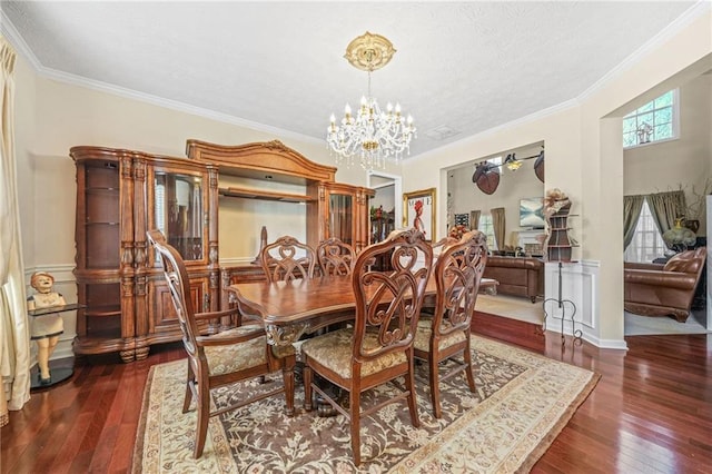 dining room featuring a chandelier, ornamental molding, a textured ceiling, and hardwood / wood-style flooring